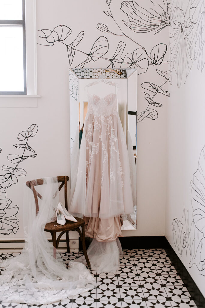 A wedding gown hanging for wedding prep details